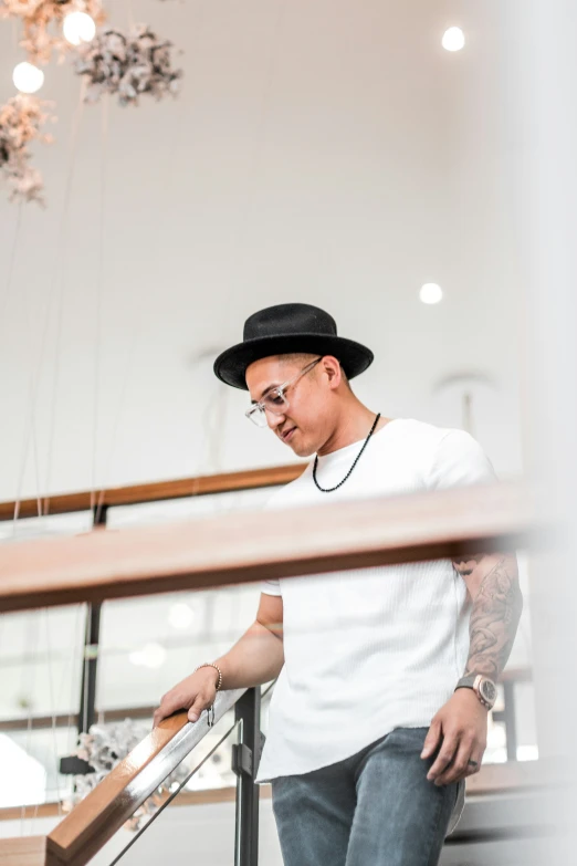 a man standing on a staircase next to a chandelier