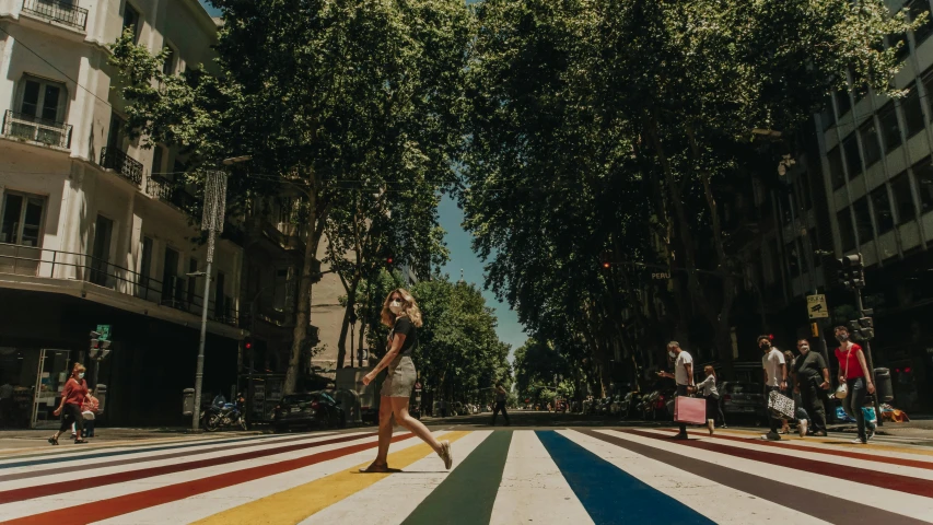 woman with handbag walking down a multi colored street