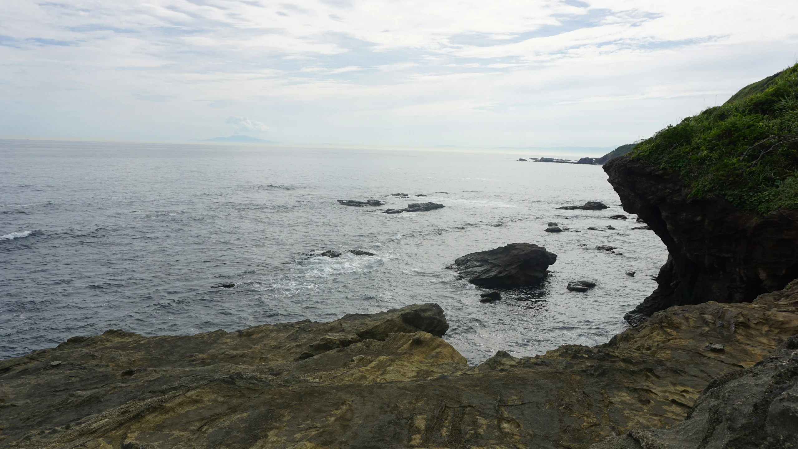 a very large rocky beach by some water