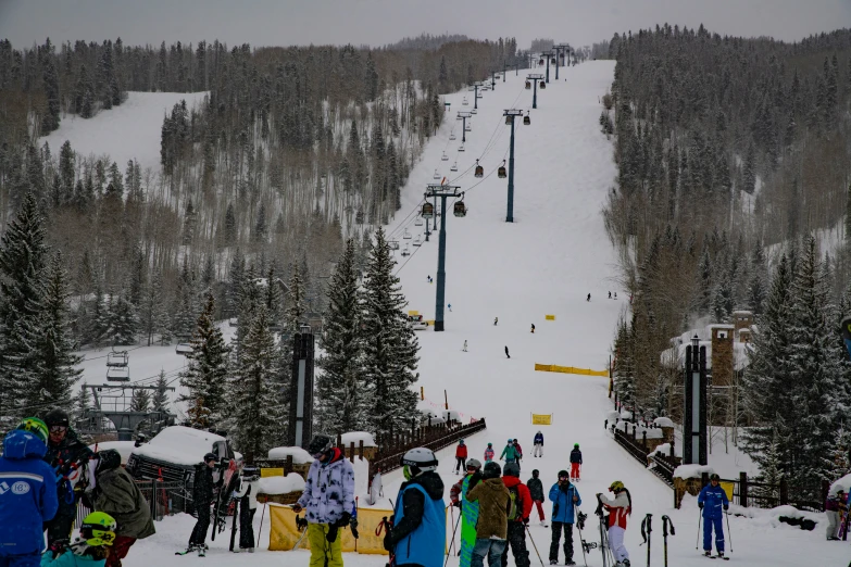 a group of people skiing down the side of a ski slope