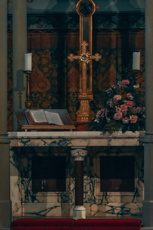 a cross with a book near it on a ledge in a church