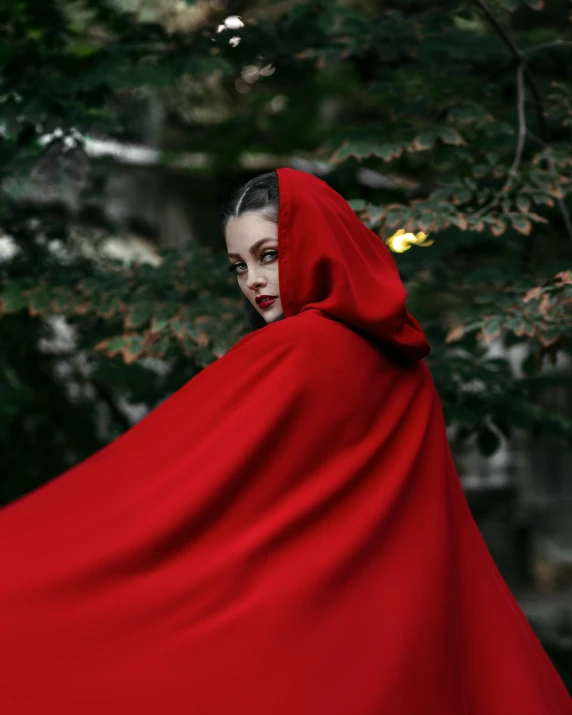 a woman dressed in red is wrapped in a red cloth