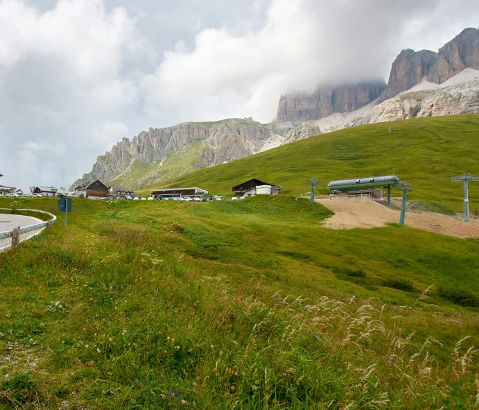 a rural green area with mountains in the background