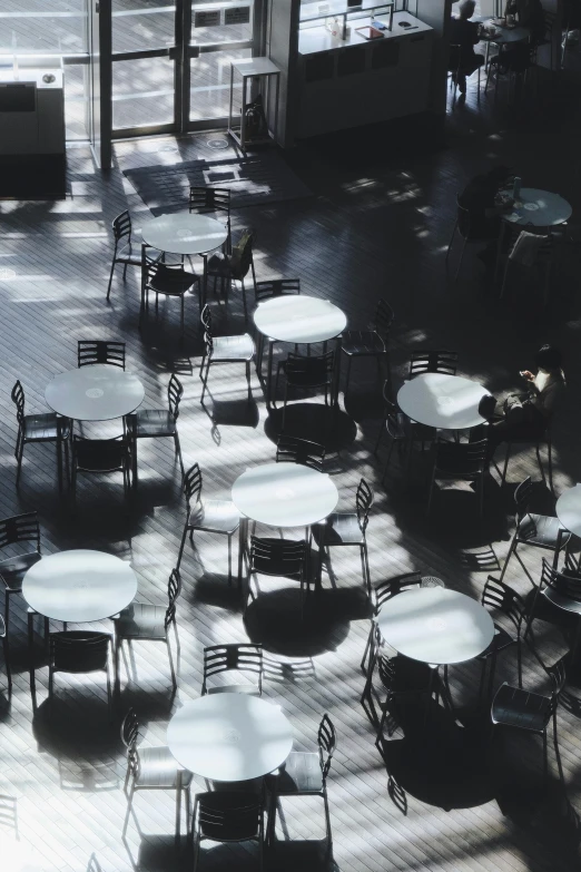 a black and white po of tables and chairs with a tiled floor