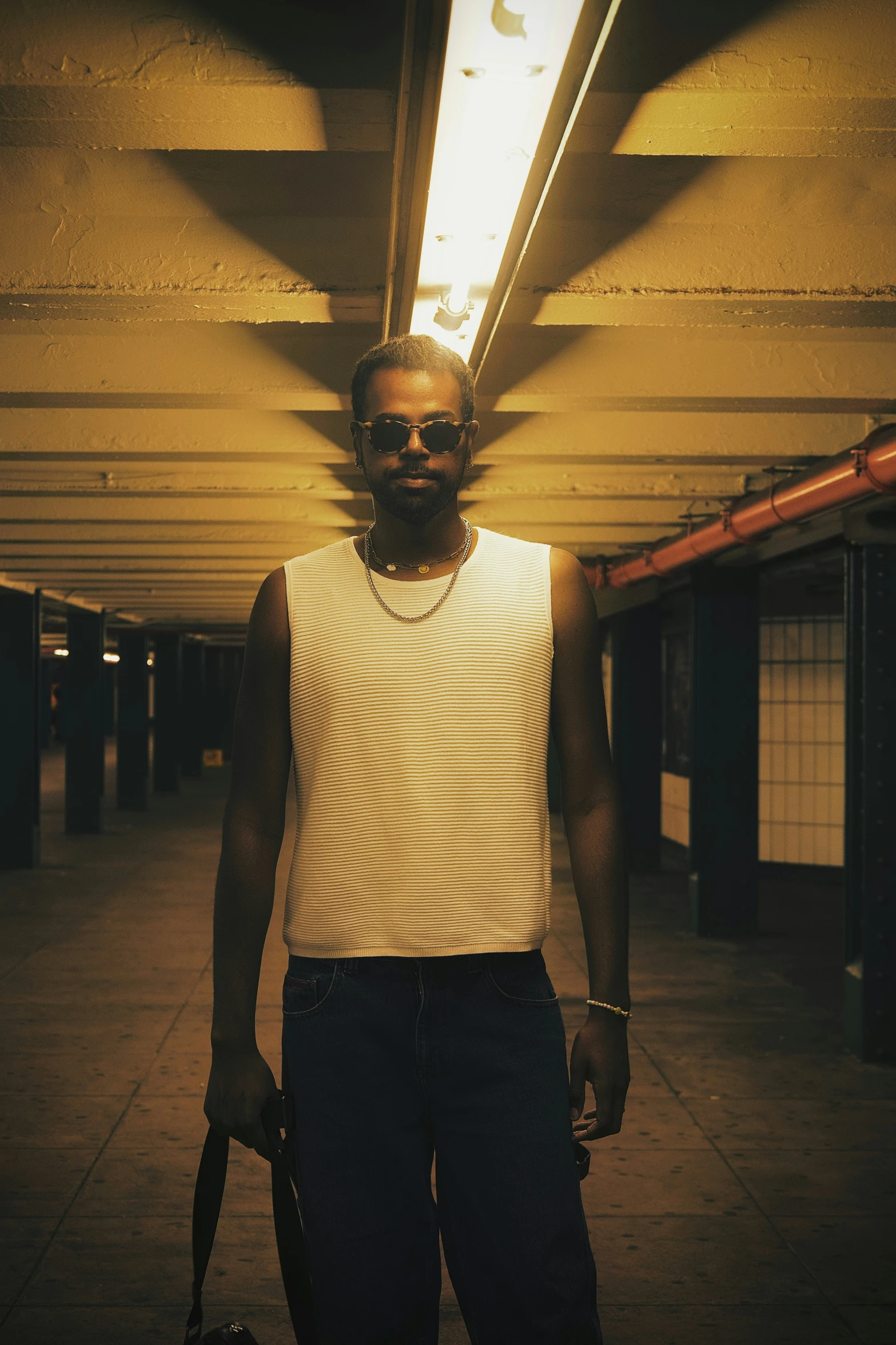 a man in a white vest posing for a picture