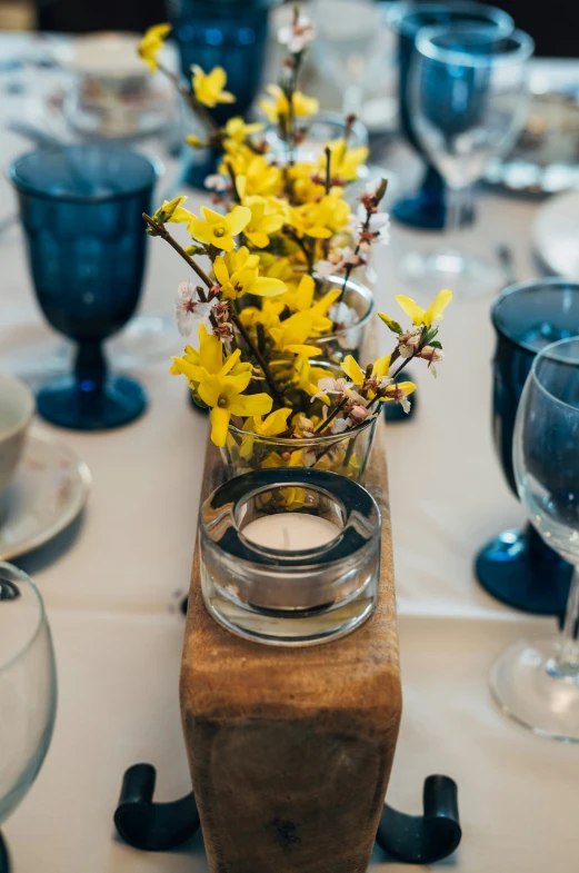 vases filled with yellow flowers sitting on a table