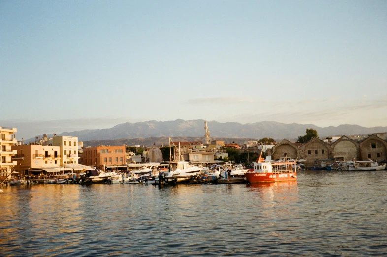 boats sitting in the water next to buildings and a shore