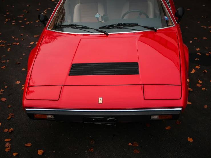 a red sports car with the hood off