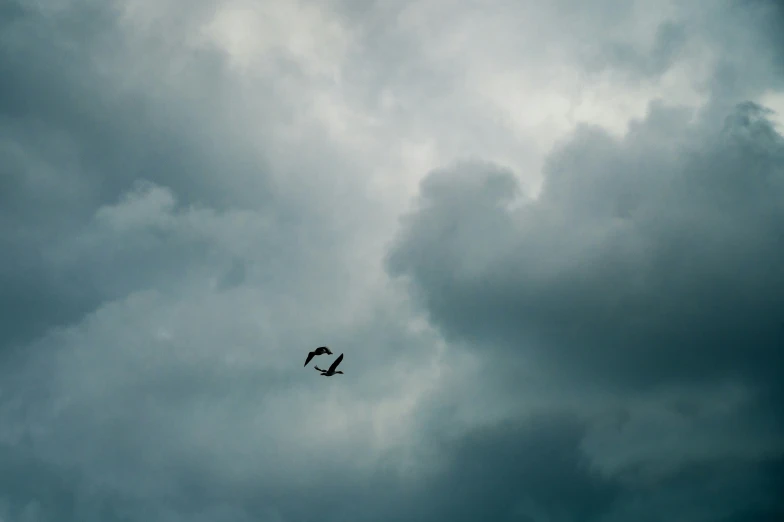 an airplane flies high into the clouds on a stormy day