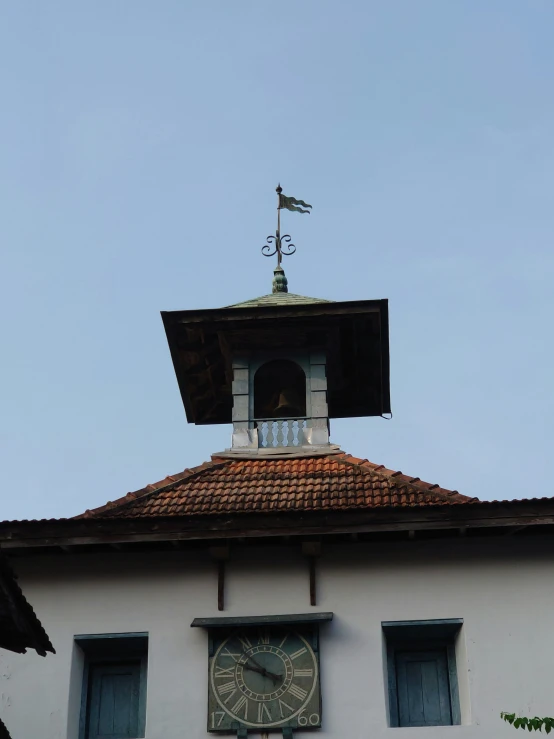 a clock tower is set high above a roof