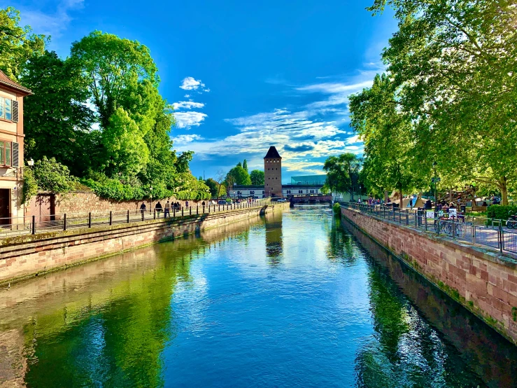 the blue water is still clear and reflecting the surrounding buildings