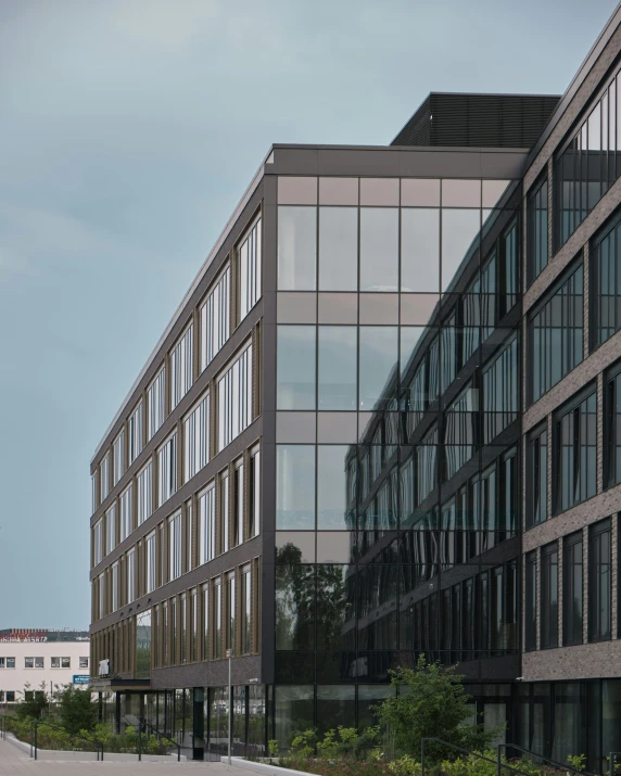 two large building sit side by side one has windows on it