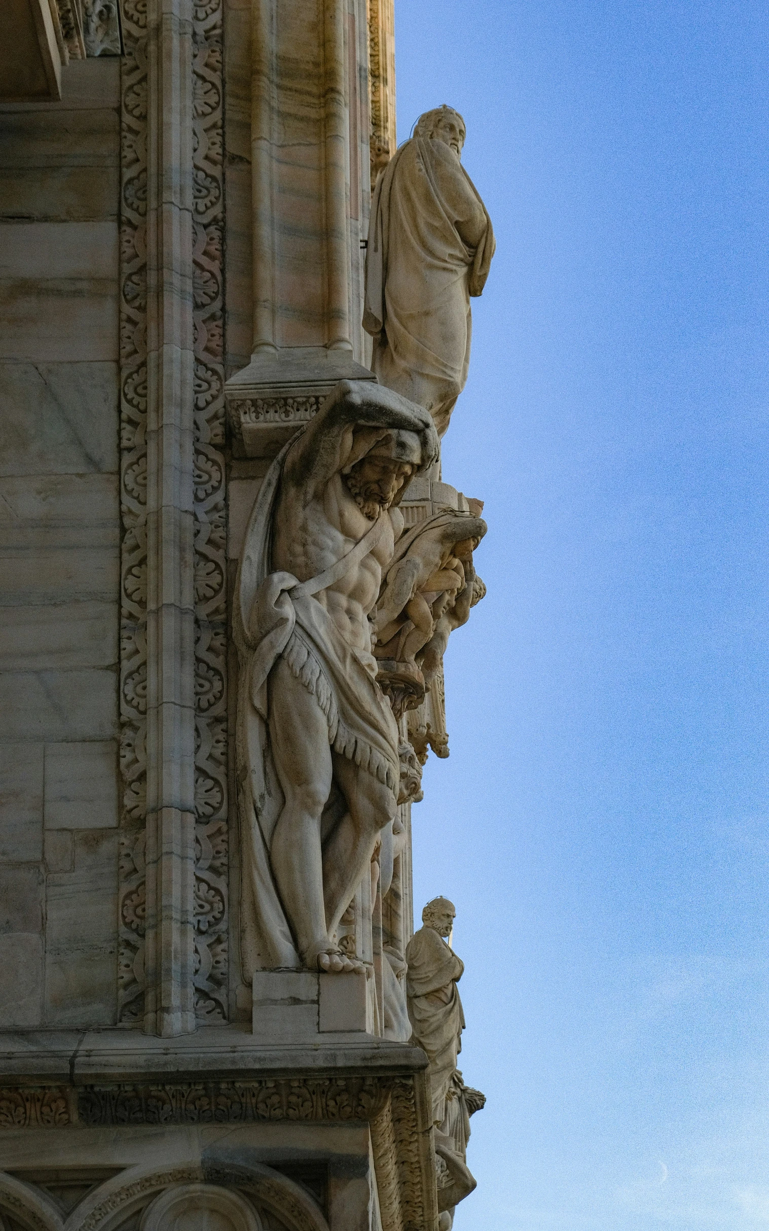 a close up of a statue on the side of a building