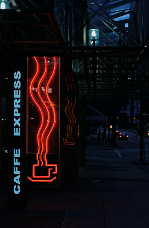 an illuminated advertit for a coffee house at night