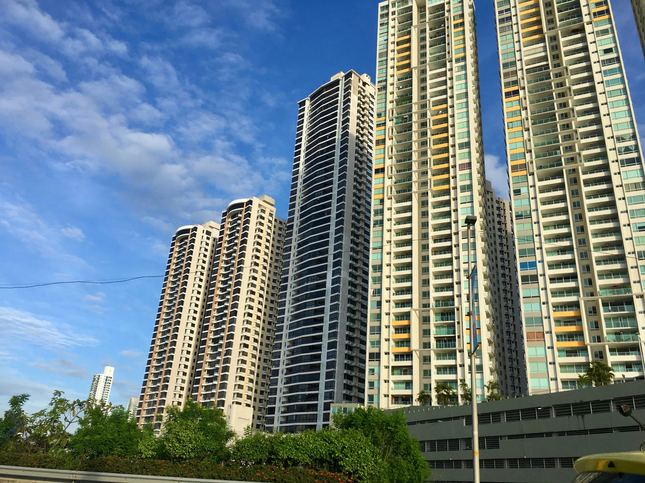 the tall buildings stand against the blue sky