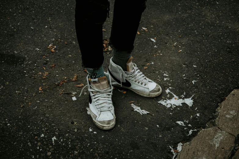 a person standing up with some tennis shoes