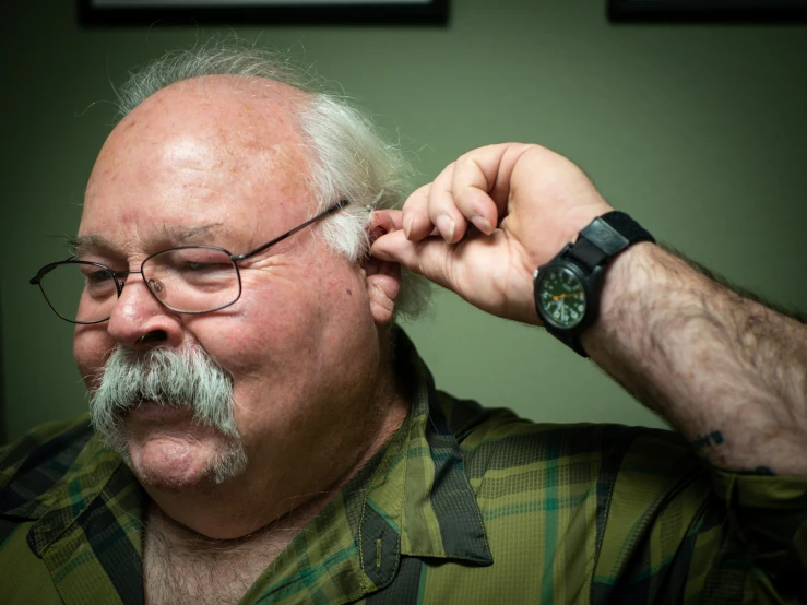 a man with a white mustache wearing glasses