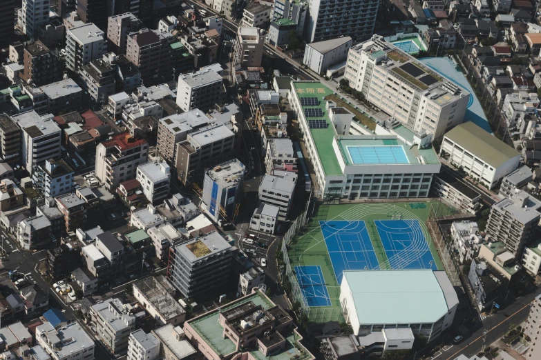 an aerial po of tennis courts and buildings