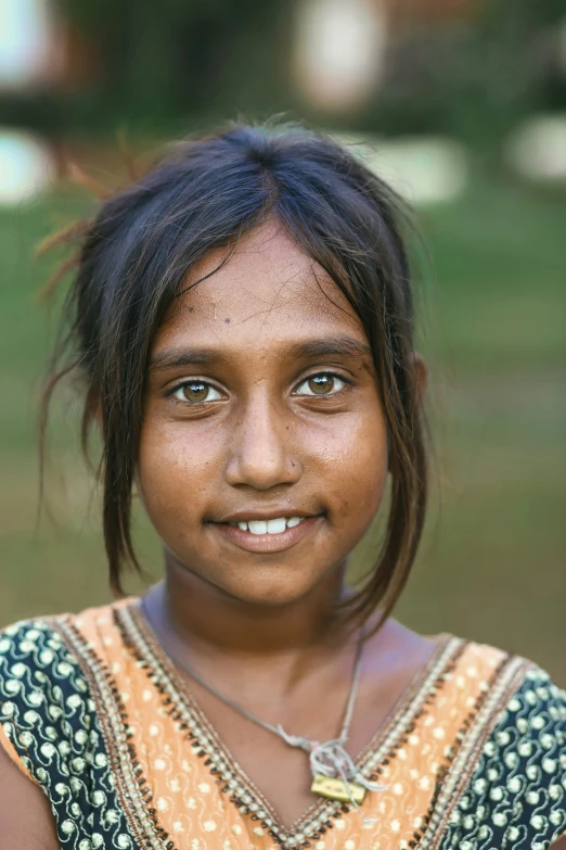 a young indian girl with dark blue eyes and freckled hair