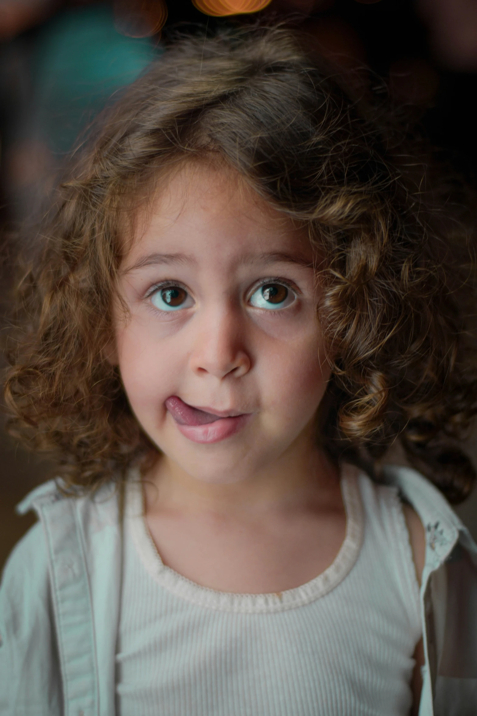 a little girl with big blue eyes smiling