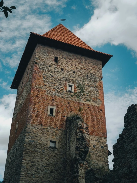 a tall brick tower with an intricate stone wall