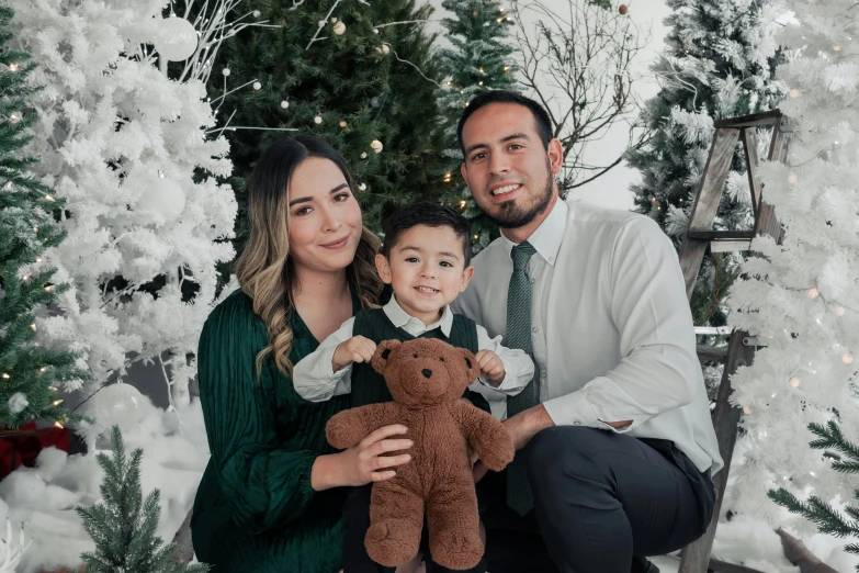 family with a teddy bear on christmas morning