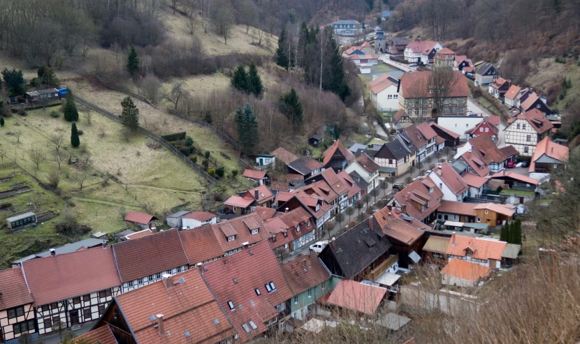an aerial view of a large village next to a valley