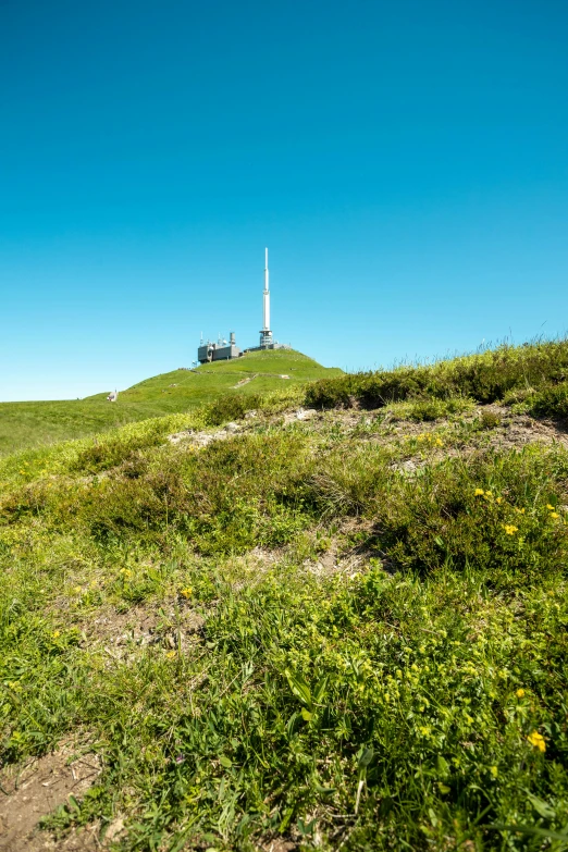 the building is sitting on the hill with a clear sky