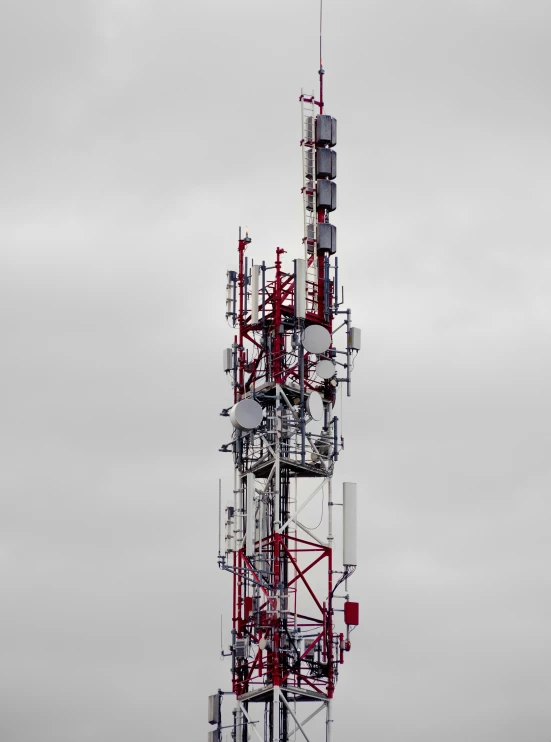 a large tower with antennas in the middle of nowhere