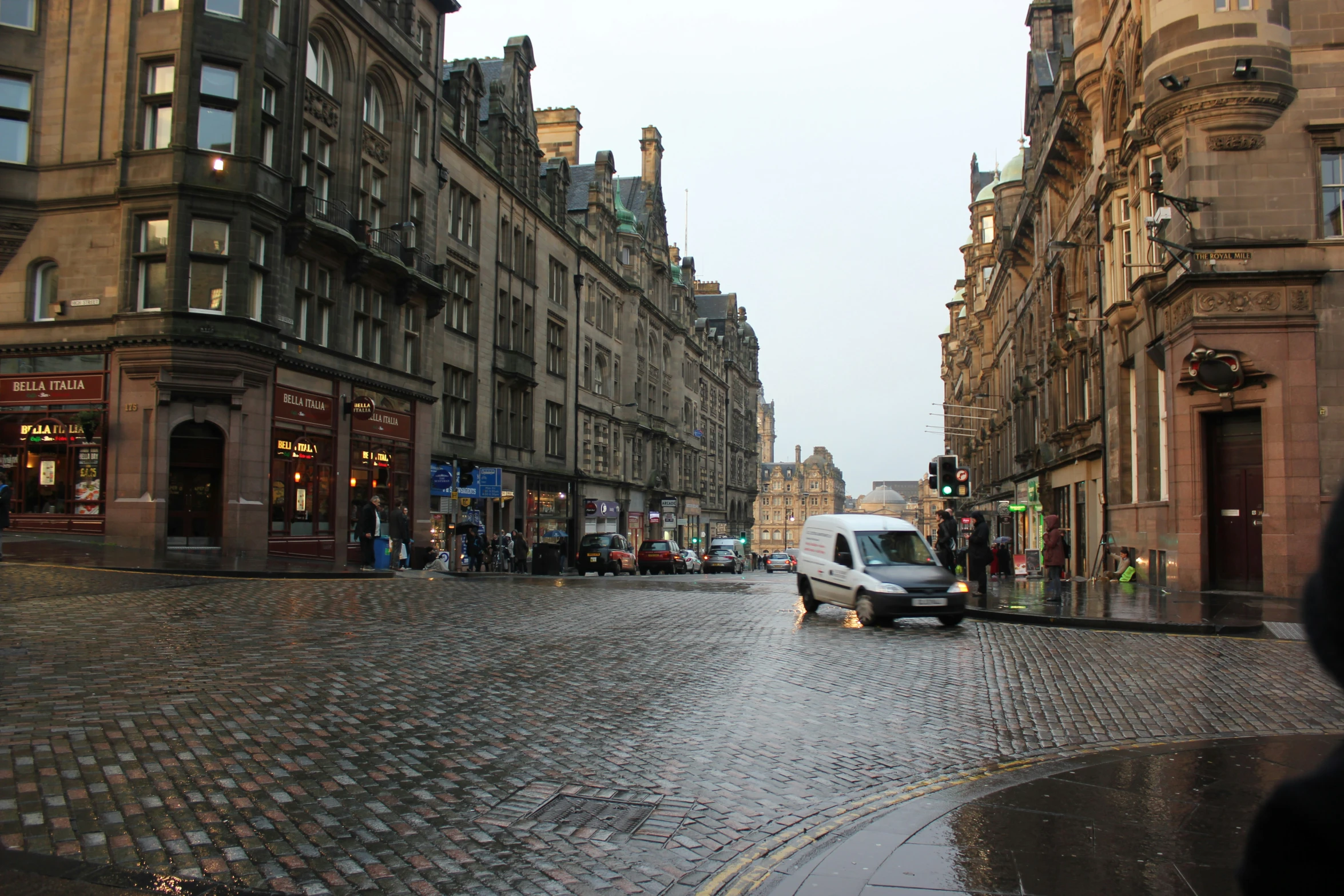 a very wide paved road in the middle of an old city