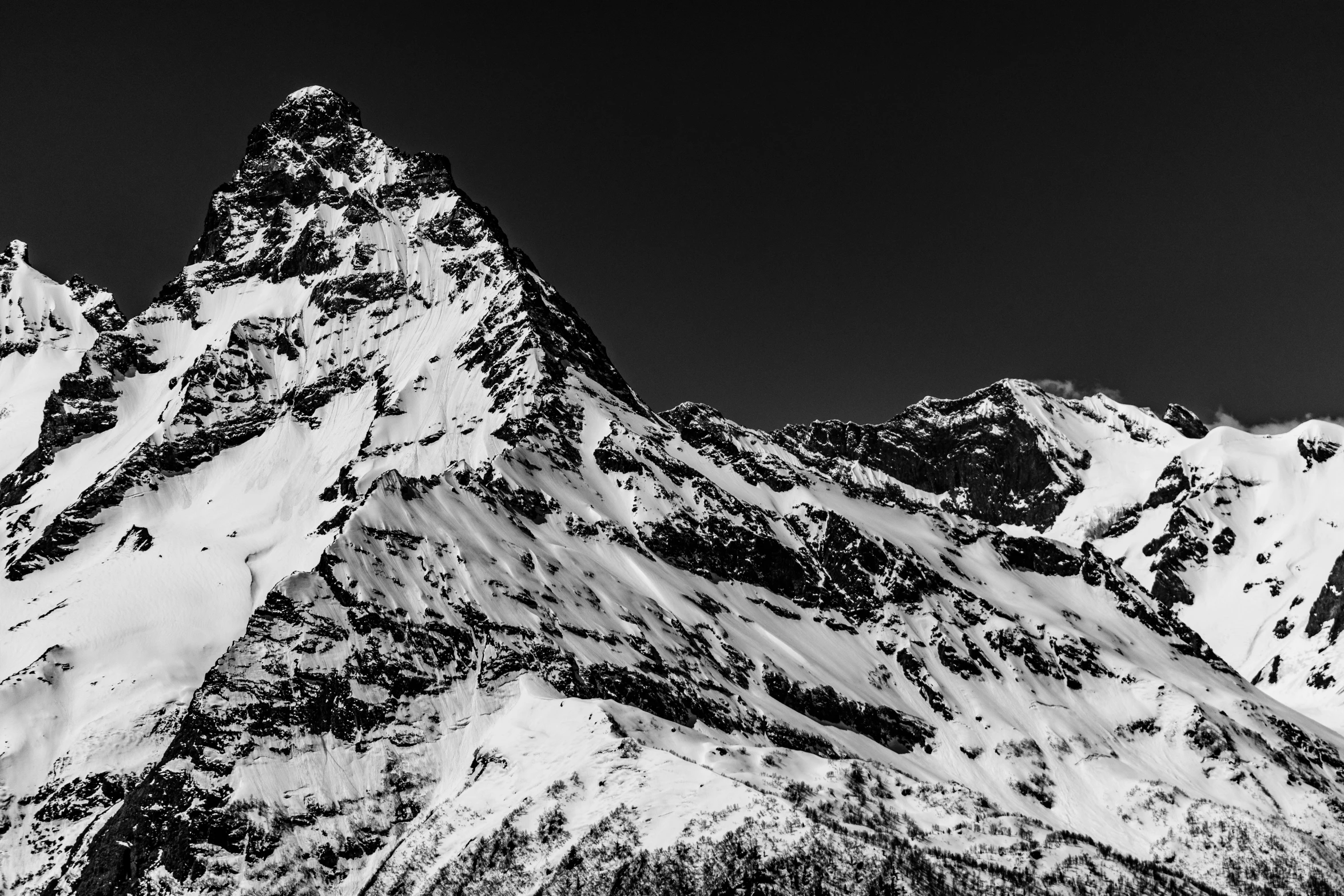 black and white image of snow covered mountain tops