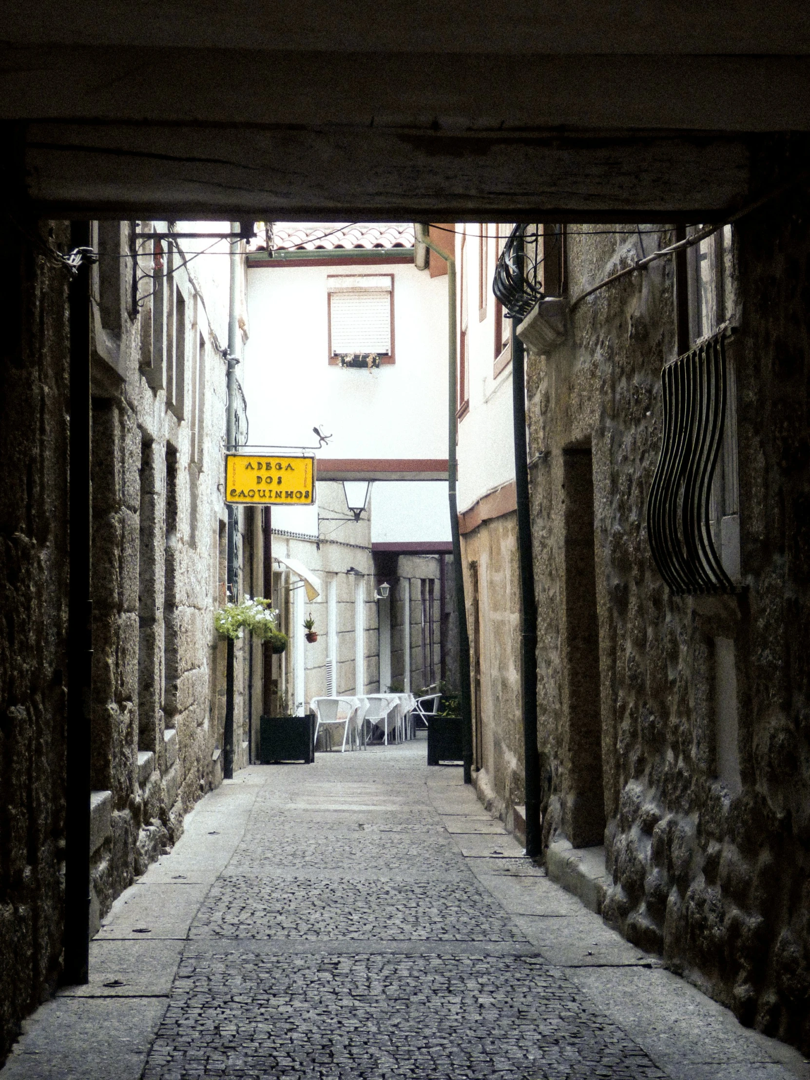 a narrow street is seen through the open doors