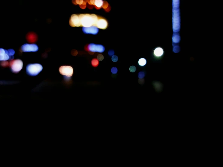 a blurry pograph of a street at night