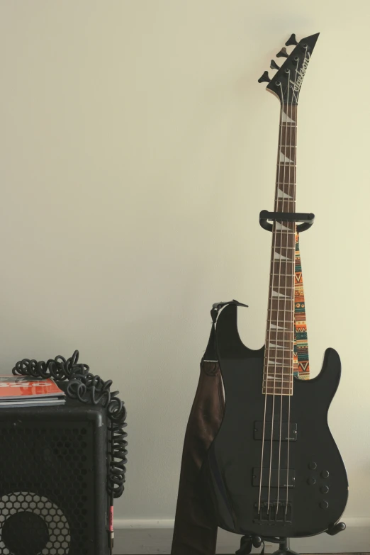 a bass guitar sitting next to a speaker