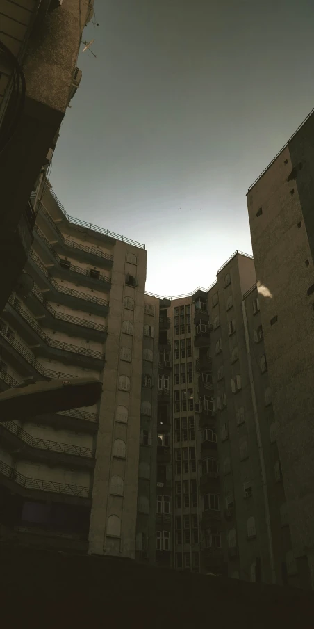 two buildings seen from the ground with sky above