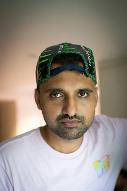 man with head band wearing a green and black hat