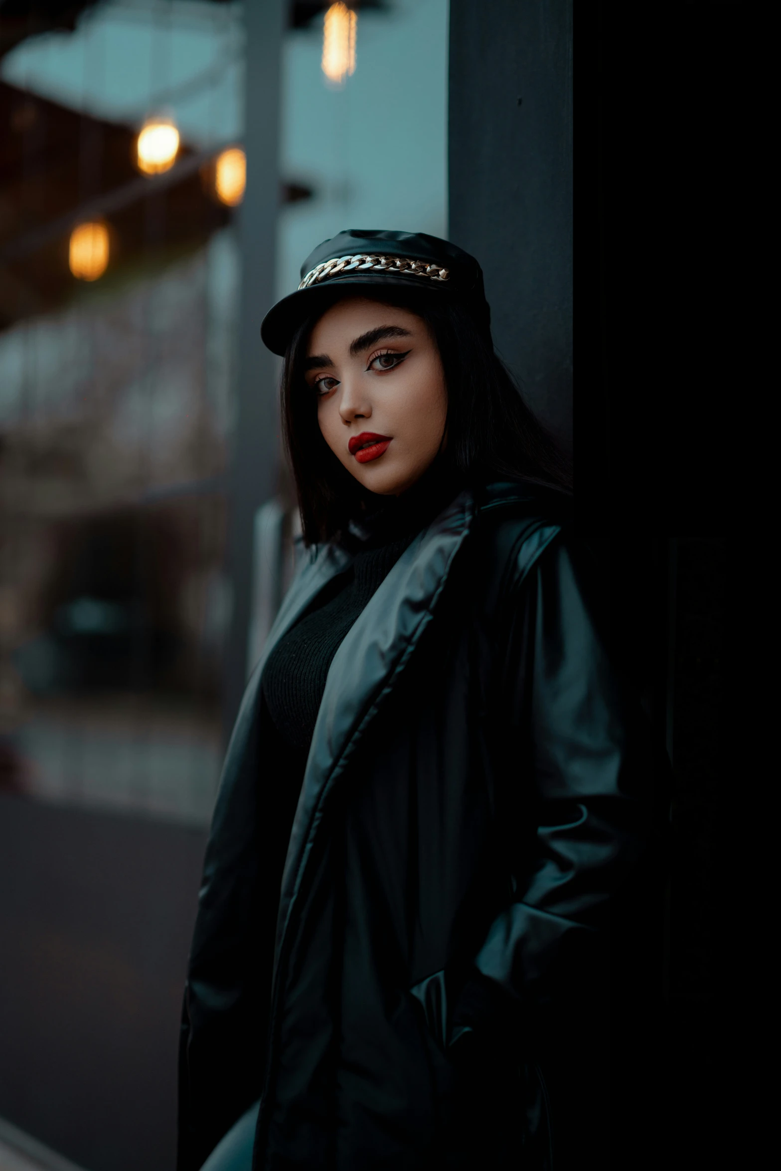 a girl leaning against a wall and looking off to the side