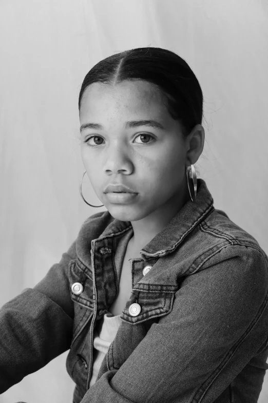 a black and white po of a woman in a denim jacket