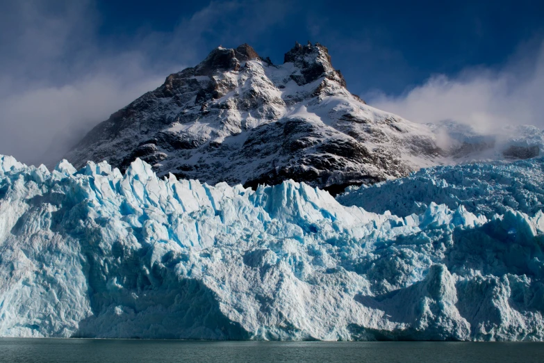 a massive blue and white ice floating in the water