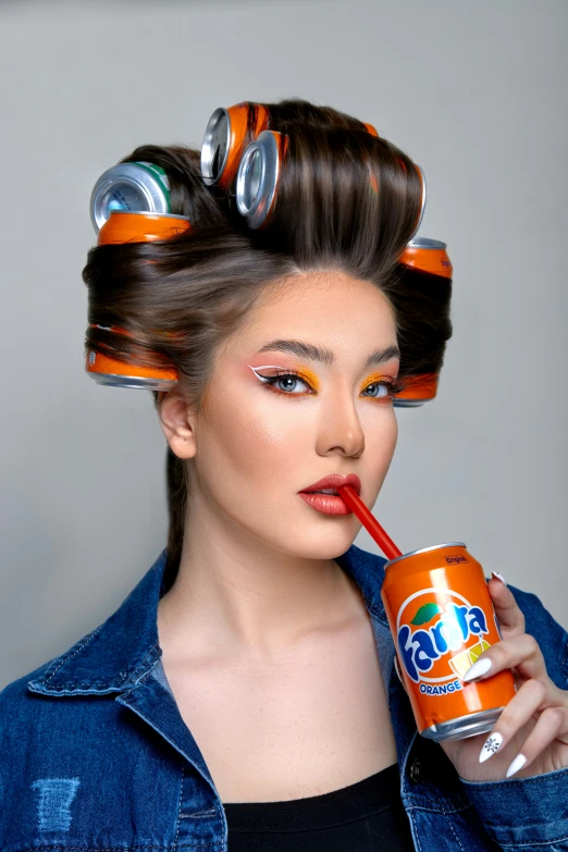 a young lady wearing large orange and silver curl - ups drinking a can of soda