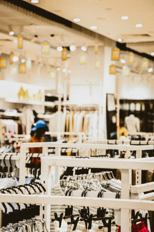 the people are shopping for items in a clothing store