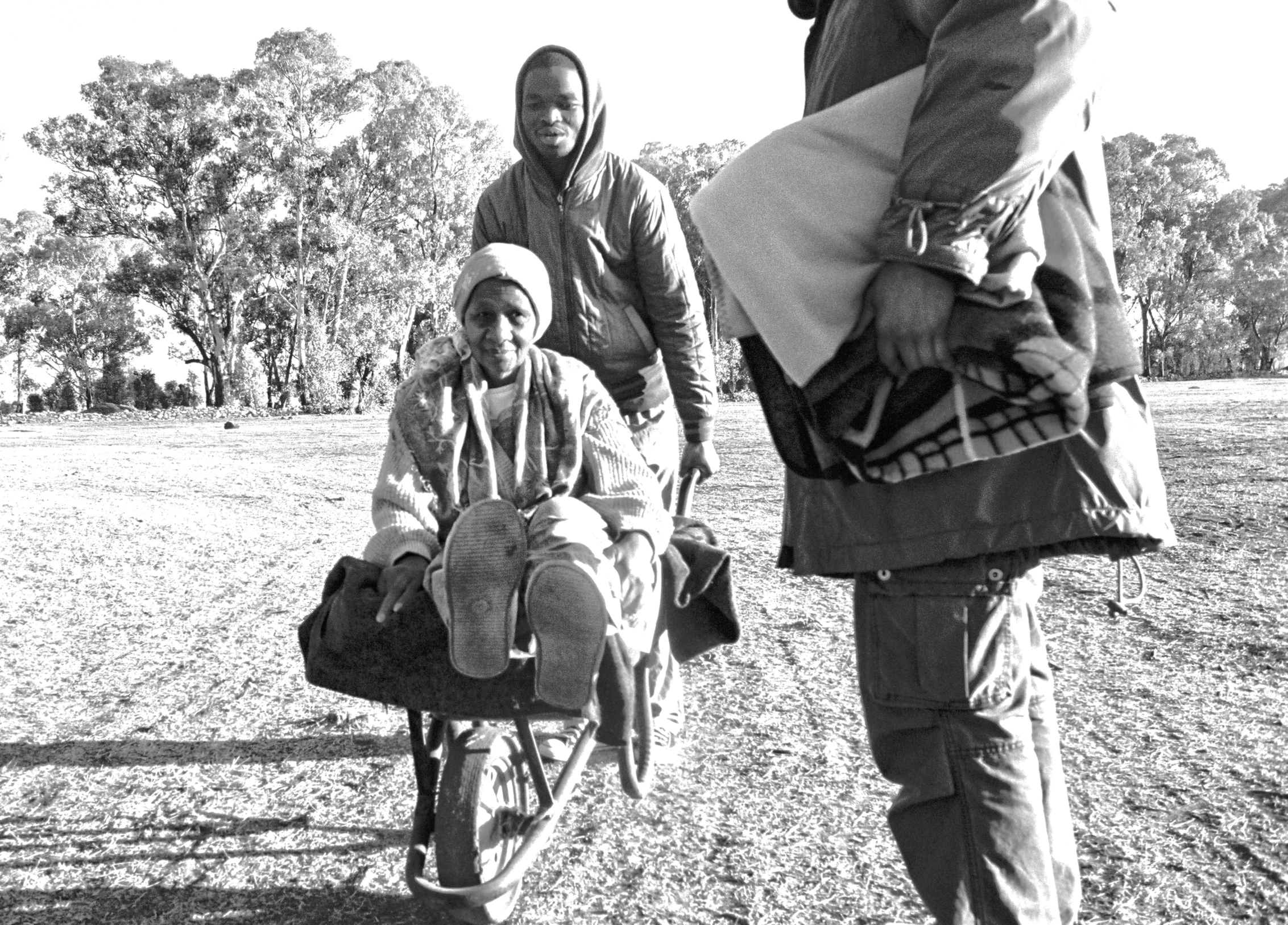 a group of men walking down a dirt road