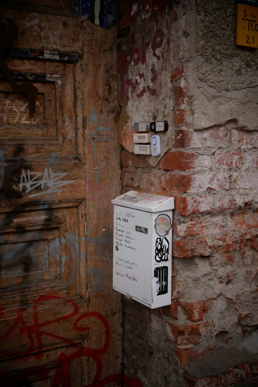 a wall with graffiti and a light switch