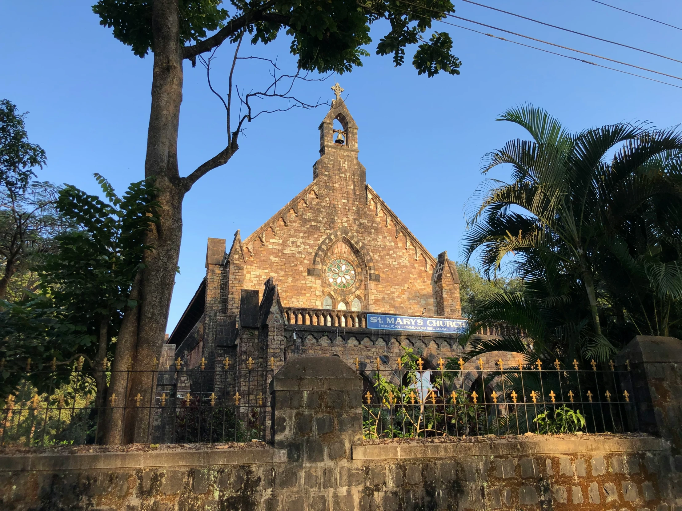 an old cathedral with a steeple rises above the trees