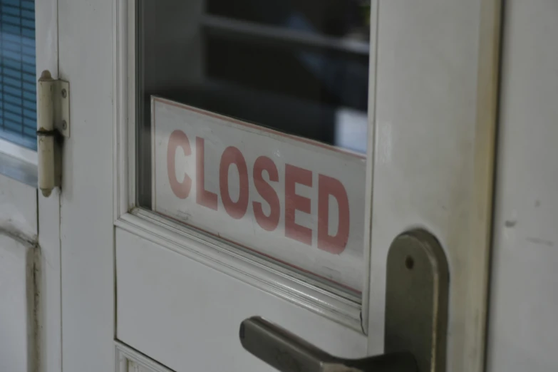a closed sign is displayed on a door