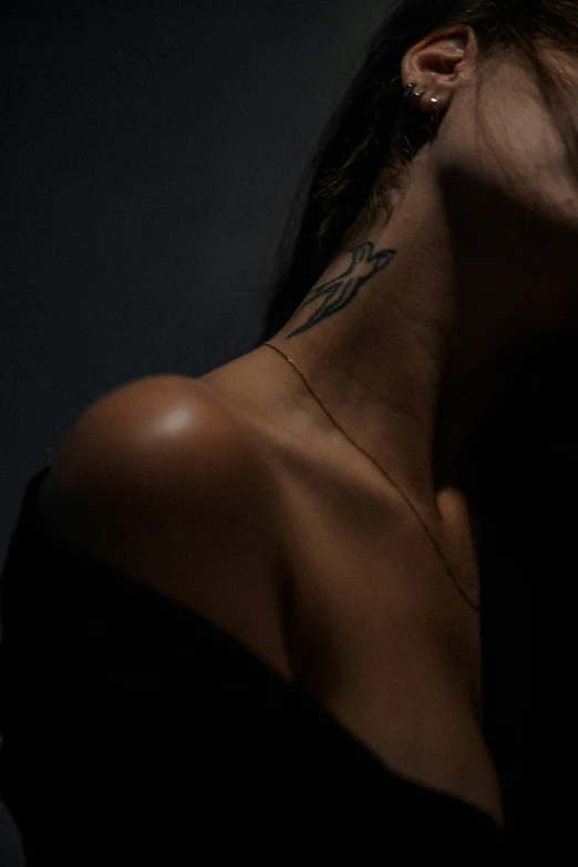 an open neck and a woman with tattoos on it