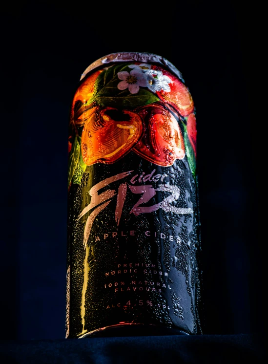 a colorful can is on the table on black background