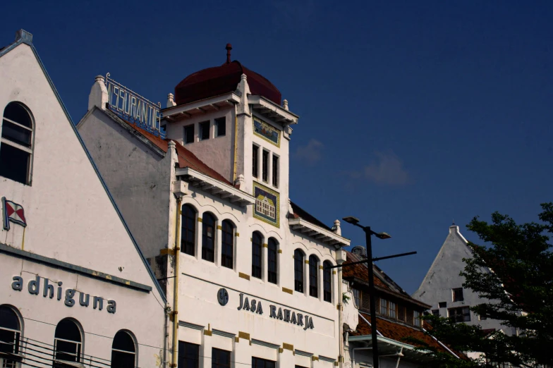 the building has a tower with windows, and is white