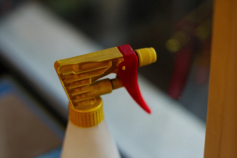 close up of a yellow handle of a wooden cabinet