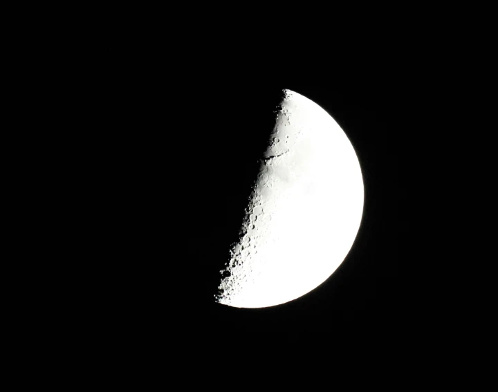 a small moon is shown at night, with black background